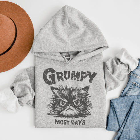 Introducing the "Grumpy Most Days" Hoodie—because let's face it, some days just require a permanent scowl. Featuring the grumpiest cat you’ve ever seen, this hoodie is perfect for those days when coffee, sunshine, or people just aren't cutting it.